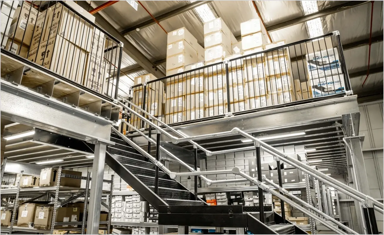 Custom mezzanine floor system with stairs and railing for multi-level warehouse storage and workspace